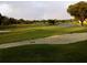 Beautiful golf course view with lush green grass, lake, and a rainbow at 5449 Downham Mdws, Sarasota, FL 34235
