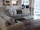 Comfortable living room with sofa, glass table, patterned rug, and decorative accents at 5449 Downham Mdws, Sarasota, FL 34235