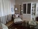 Inviting living room featuring a cozy armchair with ottoman, stylish hutch, and elegant decor at 5449 Downham Mdws, Sarasota, FL 34235