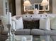 Cozy living room with elegant sofa, decorative pillows, and chic decor at 5449 Downham Mdws, Sarasota, FL 34235