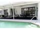 Relaxing outdoor patio with comfortable seating, surrounded by a pool and a view of the golf course at 5449 Downham Mdws, Sarasota, FL 34235