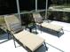 Inviting poolside with lounge chairs and pillows, perfect for relaxation at 5449 Downham Mdws, Sarasota, FL 34235