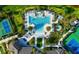 Aerial view of the community pool area, showcasing pools, hot tub, tennis courts, and landscaping at 5750 Long Shore Loop, Sarasota, FL 34238