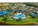 Aerial view of the community pool, tennis courts, and surrounding lush landscaping at 5750 Long Shore Loop, Sarasota, FL 34238