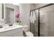 A modern bathroom featuring a white vanity, marble countertop, and a glass-enclosed shower at 5750 Long Shore Loop, Sarasota, FL 34238