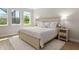 Bright bedroom with neutral color scheme, wood furniture, and natural light at 5750 Long Shore Loop, Sarasota, FL 34238