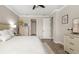 A well-lit primary bedroom with light wood flooring and furniture, neutral walls and a ceiling fan at 5750 Long Shore Loop, Sarasota, FL 34238