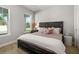 Comfortable bedroom featuring wood-look flooring and a queen bed with stylish accents at 5750 Long Shore Loop, Sarasota, FL 34238