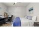A well-lit bedroom includes a work desk and charming decor with blue accents at 5750 Long Shore Loop, Sarasota, FL 34238