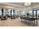 Clubhouse interior dining area with views of exterior, chandeliers, and large tables at 5750 Long Shore Loop, Sarasota, FL 34238