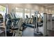 The on-site gym features modern exercise equipment and large windows at 5750 Long Shore Loop, Sarasota, FL 34238