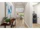 Inviting hallway featuring stylish decor and leading to open living spaces with a pool view at 5750 Long Shore Loop, Sarasota, FL 34238