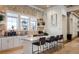 The clubhouse kitchen boasts sleek cabinetry, granite countertops, and barstool seating at 5750 Long Shore Loop, Sarasota, FL 34238