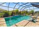 Relaxing screened-in pool area with in-pool seating and ample space for patio furniture and decor at 5750 Long Shore Loop, Sarasota, FL 34238
