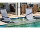Unique pool design features submerged lounge chairs and water fountains for ultimate relaxation at 5750 Long Shore Loop, Sarasota, FL 34238