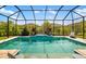 Stunning pool with sparkling water and a screened enclosure for year-round enjoyment at 5750 Long Shore Loop, Sarasota, FL 34238