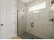 A walk-in shower featuring grey tile, glass enclosure, and a rain shower head at 5750 Long Shore Loop, Sarasota, FL 34238