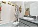 Cozy bathroom with tub, patterned shower curtain, and decorative fish accents at 5802 Alabaster Stone Ln, Apollo Beach, FL 33572
