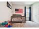 Bedroom showcasing a crib, American flag, and a window with blue star curtains at 5802 Alabaster Stone Ln, Apollo Beach, FL 33572