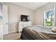 Bedroom with a TV on a dresser, neutral carpet, and natural light from a window at 5802 Alabaster Stone Ln, Apollo Beach, FL 33572