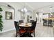 Cozy dining area with a round table, modern lighting, and views into the kitchen at 5802 Alabaster Stone Ln, Apollo Beach, FL 33572