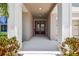 Inviting entryway with beautiful landscaping, columns, and a double-door entry at 5802 Alabaster Stone Ln, Apollo Beach, FL 33572