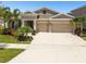 Charming single-Gathering home with a two-car garage and lush landscaping in a desirable neighborhood at 5802 Alabaster Stone Ln, Apollo Beach, FL 33572