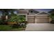 Elegant home boasts a multi-car garage, lush landscaping, and stylish architectural details at 5802 Alabaster Stone Ln, Apollo Beach, FL 33572