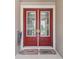 Close-up of a beautiful front door with glass panels and welcome mats at 5802 Alabaster Stone Ln, Apollo Beach, FL 33572