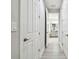 Hallway featuring multiple doors, leading to the Primary bathroom at 5802 Alabaster Stone Ln, Apollo Beach, FL 33572