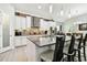 Kitchen island with seating, pendant lights, and a view of stainless steel appliances at 5802 Alabaster Stone Ln, Apollo Beach, FL 33572