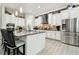 Bright kitchen with white cabinets, stainless steel appliances, and a large center island at 5802 Alabaster Stone Ln, Apollo Beach, FL 33572