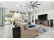 Bright living room with large windows, modern furnishings, and stylish decor at 5802 Alabaster Stone Ln, Apollo Beach, FL 33572