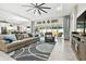 Spacious living room with stylish furniture, large windows, and seamless access to the outdoor area at 5802 Alabaster Stone Ln, Apollo Beach, FL 33572