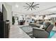 Open-concept living space featuring a modern ceiling fan and gray and blue accents throughout at 5802 Alabaster Stone Ln, Apollo Beach, FL 33572