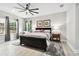 Bedroom with neutral tones, a ceiling fan, and plenty of natural light from large windows at 5802 Alabaster Stone Ln, Apollo Beach, FL 33572