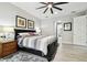 Bright main bedroom featuring wood-look flooring, a ceiling fan, and a decorative accent wall at 5802 Alabaster Stone Ln, Apollo Beach, FL 33572