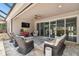 Covered outdoor patio includes tv, ceiling fan, and comfortable wicker furniture at 5802 Alabaster Stone Ln, Apollo Beach, FL 33572
