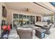 Covered outdoor patio with entertainment area featuring a ceiling fan and comfortable wicker seating at 5802 Alabaster Stone Ln, Apollo Beach, FL 33572