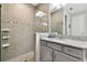 Shower with decorative tile, a granite countertop vanity, and glass doors at 5802 Alabaster Stone Ln, Apollo Beach, FL 33572