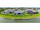 Aerial view of the rear of home on the lake and nicely landscaped backyard at 5910 Hevena Ct, Palmetto, FL 34221