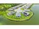 Areal view of home, pond, and surrounding community featuring lush landscaping, solar panels, and cul-de-sac at 5910 Hevena Ct, Palmetto, FL 34221