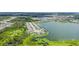 Aerial view showcasing waterfront property surrounded by lush landscaping, lake, and neighboring houses at 5910 Hevena Ct, Palmetto, FL 34221