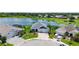 Aerial view of a home with a gray roof, beautiful landscaping, and lake view at 5910 Hevena Ct, Palmetto, FL 34221
