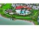 Gorgeous aerial view of the community pool, clubhouse, and playground with scenic lake views at 5910 Hevena Ct, Palmetto, FL 34221