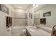 Well-lit bathroom featuring a shower-tub combo and granite countertop sink at 5910 Hevena Ct, Palmetto, FL 34221