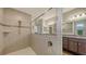 Spacious bathroom features white tiled shower with handheld shower head and glass partition at 5910 Hevena Ct, Palmetto, FL 34221