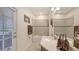 This bathroom features a bathtub, large mirror and modern design at 5910 Hevena Ct, Palmetto, FL 34221