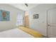 Bright bedroom showcasing a seahorse artwork and window view at 5910 Hevena Ct, Palmetto, FL 34221