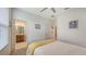 Well-lit bedroom with a ceiling fan, window, and en suite bathroom at 5910 Hevena Ct, Palmetto, FL 34221